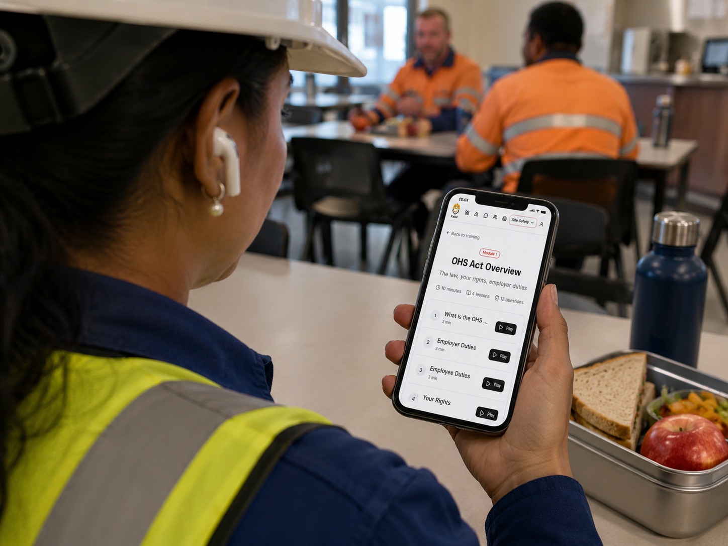 Worker completing Toolbox Talk Site Safety training on a phone during a break